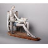 Lladro - a seated figurine Don Quixote with sword and book, on wooden plinth, No.01030, 38cm high.