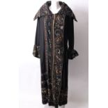 An early 20th Century full length chain stitch embroidered black silk evening coat, with cross