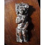 A 17th Century carved walnut panel depicting a putto holding a flower. 9cm(w) 27cm(h)
