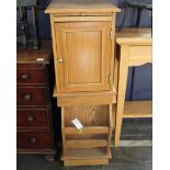 A pair of oak bedside cabinets, each with slide and single cupboard door and rear magazine rack.