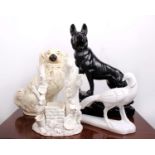 A large black pottery model of a German Shepard together with a Staffordshire flat back model of a