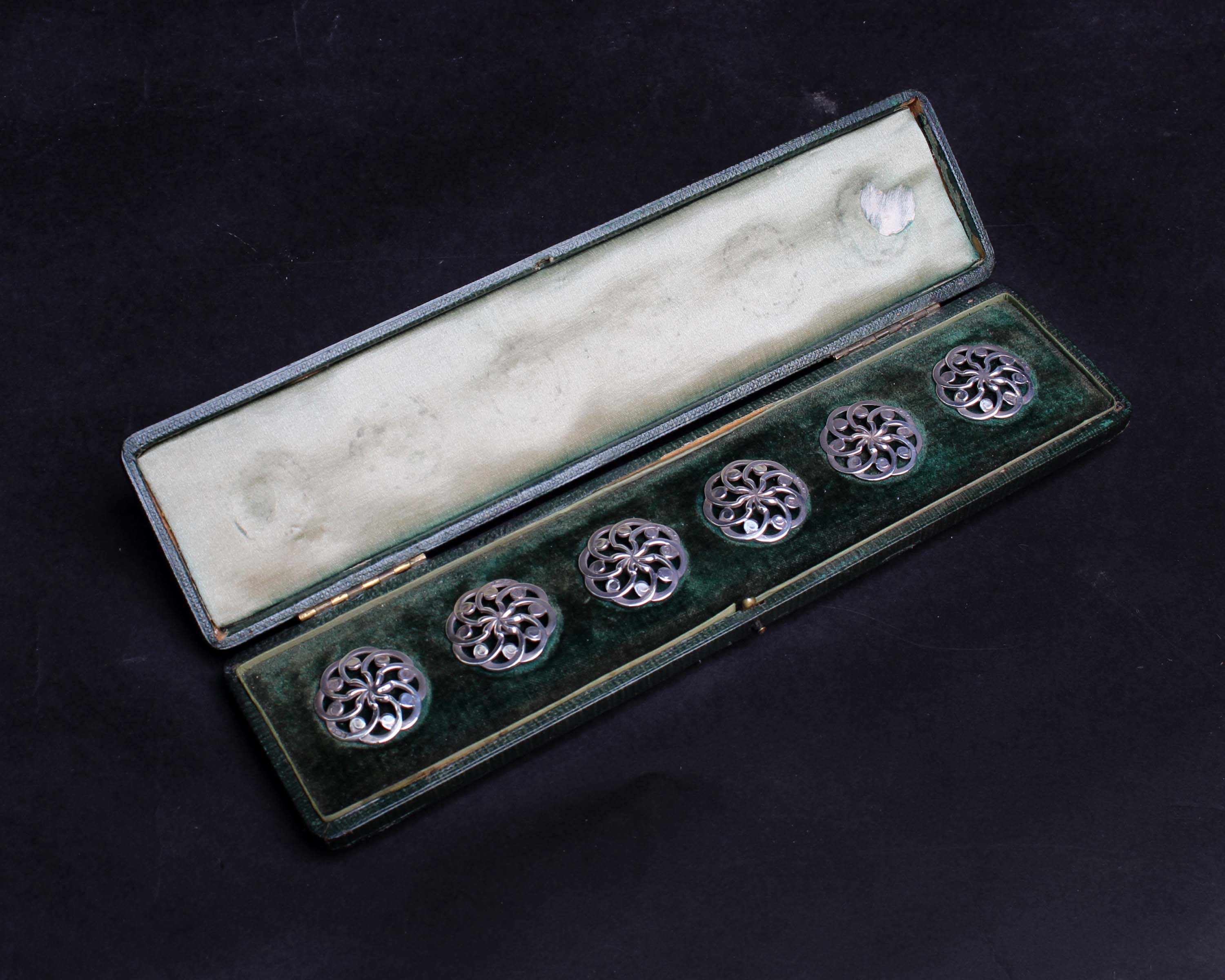 Set of six silver buttons within a velvet lined green leather case, with import marks for Samuel