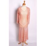 A 1930s peach coloured lace and net dress with a matching jacket; a pink full length silk