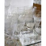 A set of four wine glasses with flared bowls and other glasses