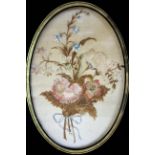 A Victorian needlework depicting a floral arrangement, presented in oval mount, and another similar,