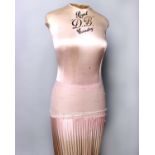 A 1930s Royal DB silk covered corsetry mannequin with a pink gathered silk skirt on a wooden stand