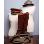 A collection of Army uniform hats, helmets, brown lace-up shoes, black boots and a pair of brown