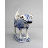 A 19th century transfer printed blue and white pottery 'cow creamer', the body applied with a