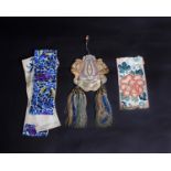 A late 19th Century Chinese embroidered silk purse decorated with tassels; a small piece of