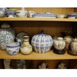 A collection of Oriental ceramics to include a large lidded onion vase, ginger jars on hard wood