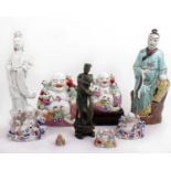 A green hard stone figure of an Oriental deity, a blanc de chine figure and other Oriental pottery