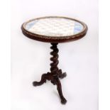 A Victorian walnut games table, with a 'chess board' top and a twisted column, height 73cm, diameter