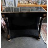 An Empire style black lacquered and gilt decorated console table, 85cm wide and a pair of black