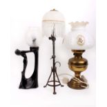 A collection of table lamps to include three brass students lamps of different designs, a ceramic
