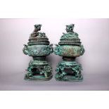 A pair of Chinese bronze Koros, each in three parts decorated all over with mythical beasts and