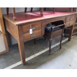 An oak writing table with inset red leatherette writing surface, 152cm wide