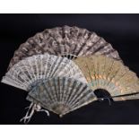 A late 19th Century Brussels lace fan within a silk box, the mother of pearl sticks and guards