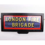 A London Fire Brigade painted sign in a glazed frame. 71cm x 31cm.