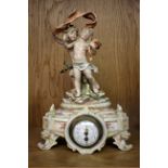 A late 19th Century Continental porcelain mantel timepiece, surmounted by figures of cherubs, the