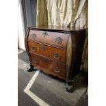 A late 18th early 19th century Dutch marquetry inlaid bow fronted bombe chest, three long drawers,
