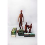 An African carved wooden figure of a young boy, signed 'Saeh' 58cm high; together with a group of