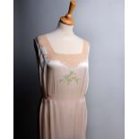 A 1930s peach coloured pleated silk nightdress with blue shoulder detail, a pale coloured nightdress