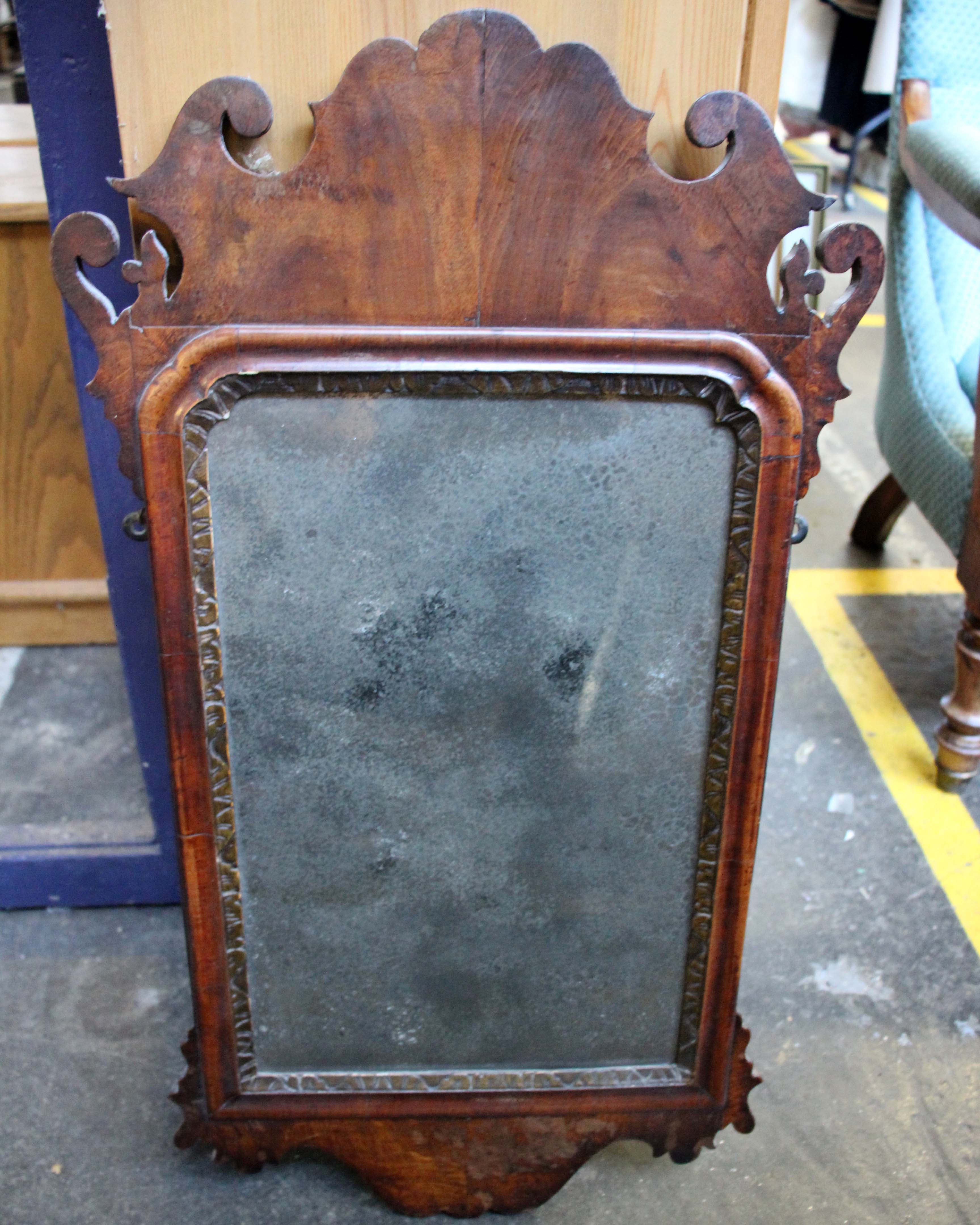 A 18th century fret carved wall mirror, with a rectangular plate, h:73cms