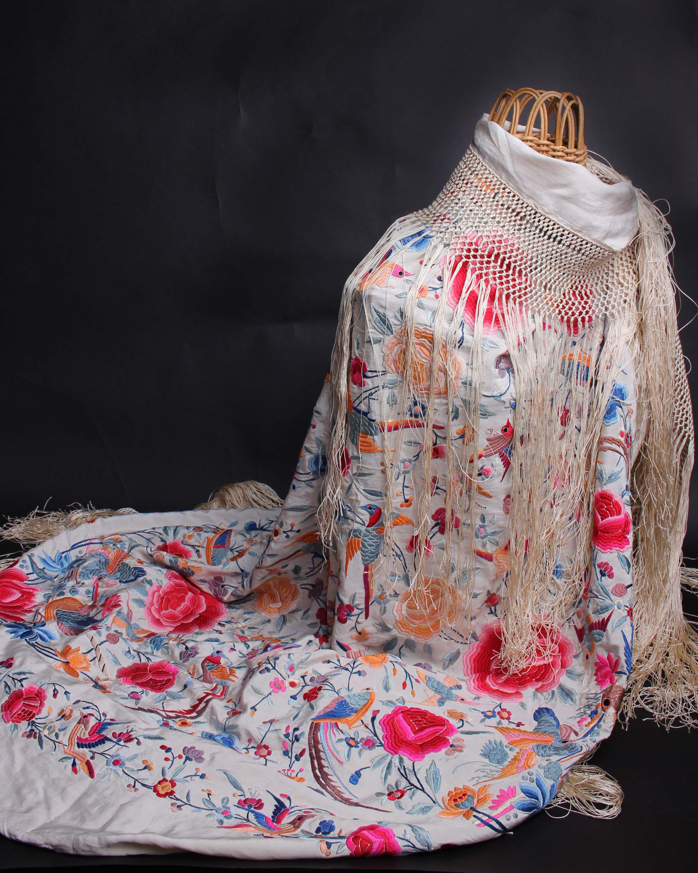 An early 20th Century cream silk fringed Chinese shawl, embroidered with large pink flowers