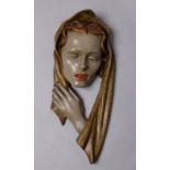 An early 20th century ceramic face mask in the manner of Goldscheider. 56cm(h) 28cm (w).