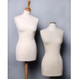 Two modern display mannequins with fabric covered polystyrene torsos on wooden stands
