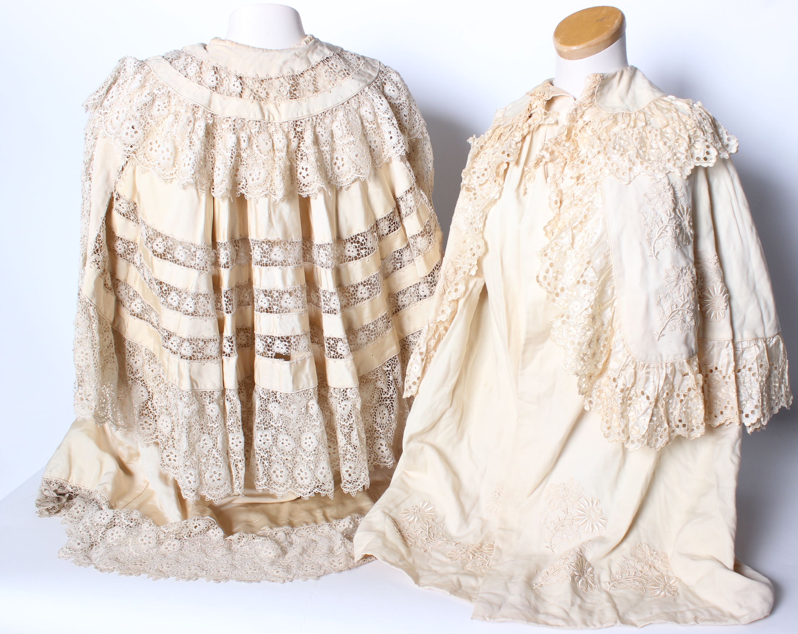 Two late 19th/early 20th Century cream lace-trimmed children's capes, and a quantity of