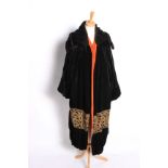 A 1920s Paris label black and orange silk velvet opera coat, decorated with an embroidered gold