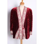 An early 20th Century red silk velvet evening jacket edged with a border of silver silk Chinese