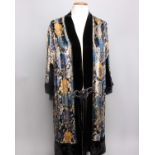 A 1920s floral patterned silk and devoré evening coat, trimmed with black velvet and dark blue