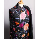 A late 19th Century black silk fringed Chinese shawl, embroidered with large pink and red flowers
