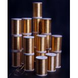 Twenty one unused wooden spools of gold coloured metallic thread, stamped Made in France