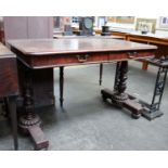 A late 19th century mahogany library table on carved supports fitted with two drawers