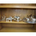 A collection of silver plated wares to include a large circular tray, a three piece tea set and