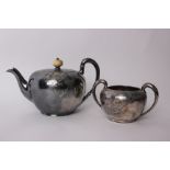 A Wilcox & Co USA silver plated tea pot and matching sugar bowl, with chased vine and leaf