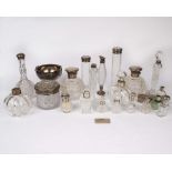 A collection of silver topped glass dressing table items and perfume bottles. .