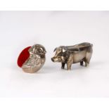 Two sterling silver pin cushions, a model of a pig by Henry Matthews, Birmingham 1911 (vacant