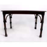 A mahogany sofa table on pierced and turned legs. 46cm (h), and an open fronted mahogany bookcase