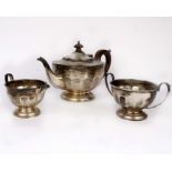 A three piece sterling silver tea set with fruit wood handle and knop by Henry Clifford Davis,