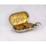 A silver plated double sovereign case with gilt interior and raised floral decoration.