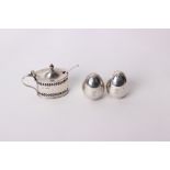 A pair of sterling silver egg shaped pepperettes by William Hutton & Sons, London 1906; together