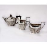 A Victorian three piece bachelors tea set with half reeded decoration and ebonised handle. by Joseph