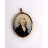 A 19th century miniature portrait of a gentleman on ivory plate in oval brass frame.