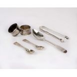 A pair of sterling silver napkin rings with chased decoration, together with four items of flat