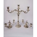 A pair of silver plated two branch candelabras together with a three branch candelabras