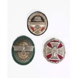 Militaria. Three replica World War II badges, the Stahlhelm badge, Bergwacht Hilfspolizeu